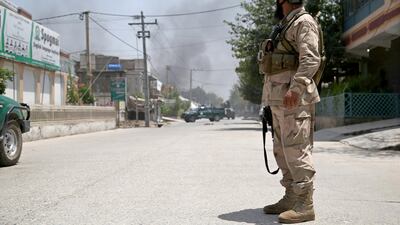 Afghan security officials secure the road leading to the scene of an attack by militants in Jalalabad, July 28. Explosions were heard amid the continuing co-ordinated attacks. EPA