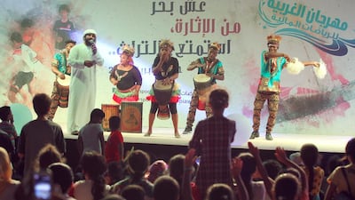 Visitors watch a drumming performance at the Al Gharbia Watersports Festival.