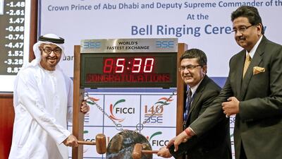 Sheikh Mohammed bin Zayed, Crown Prince of Abu Dhabi and Deputy Supreme Commander of the Armed Forces, is pictured with Ashish Chauhan (C), chief executive of the Bombay Stock Exchange, and Harshvardhan Neotia, president of the Federation of Indian Chambers of Commerce and Industry, during the bell-ringing ceremony at the BSE in Mumbai. Divyakant Solanki/EPA