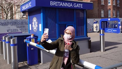 A fan takes a selfie outside of Stamford Bridge. PA