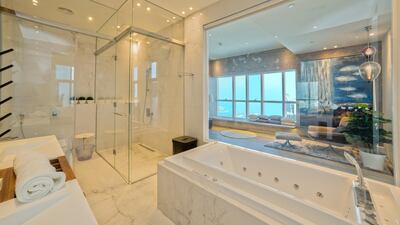 The open-plan master bathroom offers sea views. Courtesy Allsopp and Allsopp