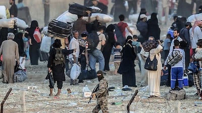 ISIL militants turn Syrian refugees back from the Akcakale crossing into Turkey on June 13, 2015. Bulent Kilic / AFP