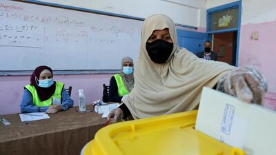 A woman casts her ballot as Jordanians began voting in a parliamentary election overshadowed by the coronavirus pandemic. AP