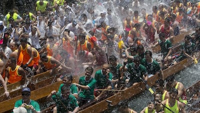 Participants splash water from their dragon boats at the Chinese Dragon Boat Festival on Saturday in Hong Kong. Tyrone Siu / Reuters