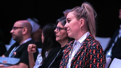 A member of the audience watching a panel called 'Taking Bollywood Global: Dynamics of Diversity'.