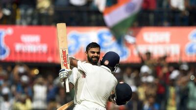 Virat Kohli, left, celebrates with teammate Ajinkya Rahane after scoring a double century. Punit Paranjpe / AFP