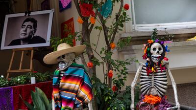 A portrait of late Argentine soccer legend Diego Maradona is displayed next to an altar at the entrance to the Mexican embassy in Buenos Aires, Argentina, during the Day of the Dead celebrations. AP Photo