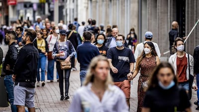 Shoppers with and without masks walk in Amsterdam, The Netherlands. EPA