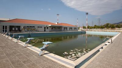 In this August 2, 2012 file photo, murky water and rubbish fill an abandoned training pool for athletes at the Olympic village on the northern fringes of Athens. The legacy of Athens’ Olympics has stirred vigorous debate, and Greek authorities have been widely criticized for not having a post-Games plan for the infrastructure. While some of the venues built specifically for the games have been converted for other uses, many are underused or abandoned, and very few provide the state with any revenue. Some critics even say that the multibillion dollar cost of the games played a modest role in the nation’s 2008 economic meltdown. Thanassis Stavrakis / AP Photo