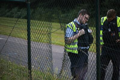 A hole was cut in a perimeter fence at Cologne-Bonn Airport in Germany as five activists blocked the runway. AP