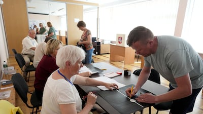People vote during the second round of presidential election in Panevezys, Lithuania. Reuters