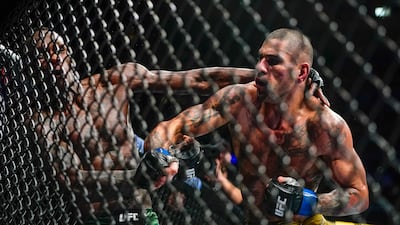Alex Pereira punches Israel Adesanya during the fifth round of their middleweight title bout. AP