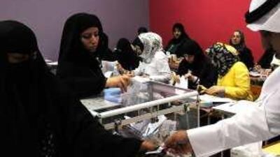 Women cast their ballots in a voting station at Daiya during Kuwait's parliamentary elections yesterday.