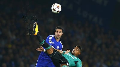 Chelsea's Cesc Fabregas, left, is challenged by Schalke's Kevin-Prince Boateng during their Champions League match on Wednesday night. Eddie Keogh / Reuters