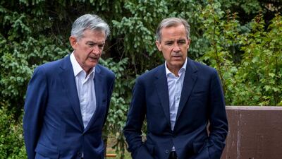 Federal Reserve Chairman Jerome Powell, left, and Bank of England Governor Mark Carney, right, walk together after Powell's speech at the Jackson Hole Economic Policy Symposium on Friday in Jackson Hole, Wyo. AP Photo/Amber Baesler