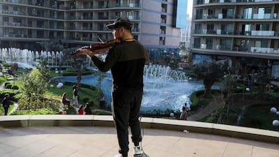 Iraqi Kurdish musician Nujin Hasan plays his violin to residents of his apartment block in Erbil. AFP