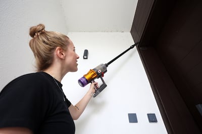 Maria Portilla deals with mayflies in her home in Emaar South. The National
