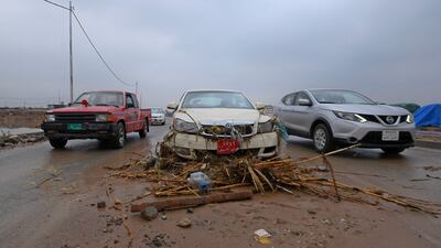 Flood-carried debris is strewn across a road Debris near Daratu.