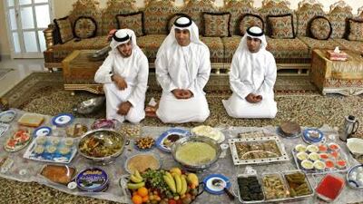 Brothers Abdulla, 27, Saeed, 28, and Ali Al Qaishi, 26, sit before the Eid feast in their late father’s Dhaya village home in Ras Al Khaimah.