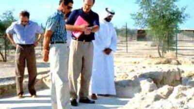 Britain's Prince Charles, front, the archaeologist Dr Geoffrey King and Ahmed Saeed Al Badi, former UAE minister of health, far right, view one of the courtyard villas during a visit to the excavation site on Sir Bani Yas island in 1993.