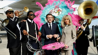 Mr Macron and his wife are serenaded on the tarmac by the Crescent City All Stars. AFP
