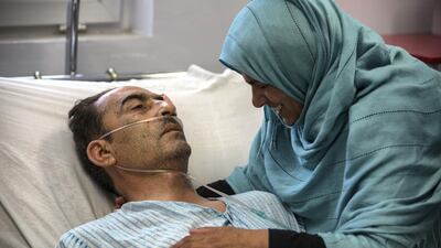 Shir Ali, 49, lies in hospital with his wife Qudsia, 48, by his side. The shock and pain of Monday's attack is raw. Stefanie Glinski for The National