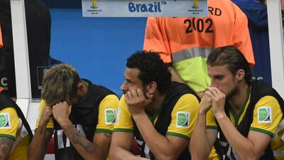 Neymar, left, covers his face as he sits next to Fred and Henrique on the bench during Brazil's third-place match loss on Saturday against the Netherlands at the 2014 World Cup in Brasilia, Brazil. Fabrice Coffrini / AFP / July 12, 2014