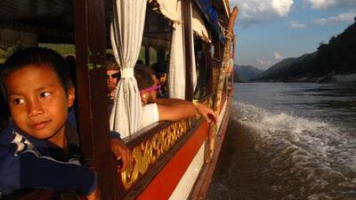Locals and tourists alike are ferried down the Mekong River from Houayaxi to Luang Prabang, Laos, on houseboats.