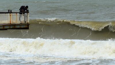 Big waves crash on the boardwalk along the Galle Face promenade during monsoon winds in Colombo, Sri Lanka. AFP