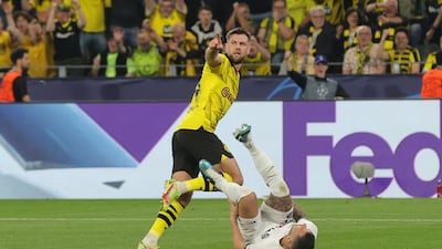 Borussia's Niclas Fullkrug (up) celebrates after scoring for the 1-0 lead against PSG, as PSG's Lucas Hernandez (down) falls after their interaction during the UEFA Champions League semi final, 1st leg match between Borussia Dortmund and Paris Saint-Germain in Dortmund, Germany, 01 May 2024. EPA / FRIEDEMANN VOGEL