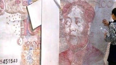 Concerns are growing that trillions of yuan borrowed by China's local authorities could lead to a crisis in the banking system. Above, a sculpture in Beijing featuring a Chinese bank note. Liu Jin / AFP