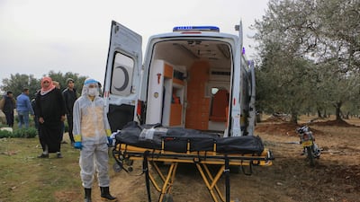 The ambulance arrives at the Salqeen cemetery in northwestern Syria. The body of a young woman who died from Covid-19 will be buried.