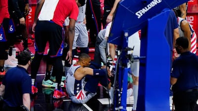Philadelphia 76ers' Joel Embiid, left, checks on Washington Wizards' Russell Westbrook after an injury during the second half of Game 2 in a first-round NBA playoff series. AP