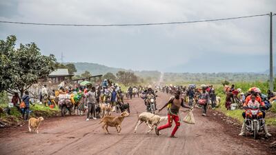 People near Kibumba in the Democratic Republic of Congo flee fighting between Congolese forces and M23 rebels in North Kivu. Congolese authorities accuse Rwandan forces of supporting armed groups in mineral-rich eastern Congo, where dozens of such groups are active. Rwanda says the allegations are baseless. AP Photo