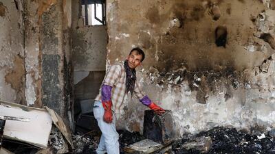 An Afghan man shows burnt iteams of his house after Sunday's attack in Kabul, Afghanistan. REUTERS
