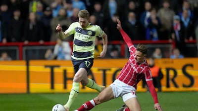 Manchester City's Kevin de Bruyne, left, is tackled by Bristol City's Cameron Pring. AP Photo