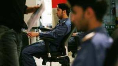 Customs inspector Ibrahim Obeid Saeed checks the suitcases of passengers at Dubai International Airport.