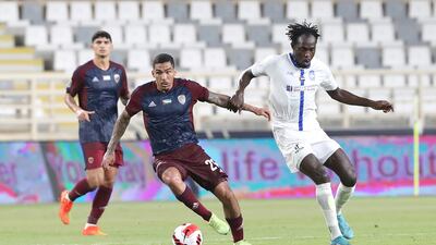 Al Wahda’s Allan Marques, left, tussles for possession with Al Nasr’s Dembo Darboe during the Adnoc Pro League match at Al Nahyan Stadium. Photo: PLC