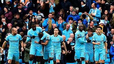 Manchester City's Spanish midfielder David Silva, second right, celebrates scoring the opening goal with teammates during the English Premier League football match against Crystal Palace at the Etihad Stadium in Manchester, north west England, on December 20, 2014. AFP PHOTO / PAUL ELLIS