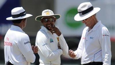 Sri Lankan cricket captain Tillakaratne Dilshan, centre, talks with umpires Aleem Dar, left, and Tony Hill, right, during a Test match between Australia and Sri Lanka in September last year.