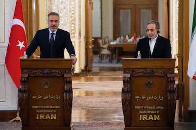 The Turkish Foreign Minister Hakan Fidan, left, speaks to the press alongside Abbas Araghchi in Tehran. AP