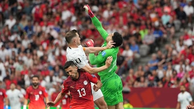 Chris Wood of New Zealand, left, in action against Egypt goalkeeper Mostafa Shobeir. EPA