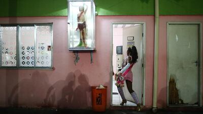 Drums queen Thalia Cristina enters a Jacarezinho samba school practice session on February 16, 2014, ahead of Carnival celebrations in Rio de Janeiro, Brazil. The Jacarezinho 'favela' was previously controlled by drug traffickers and is now occupied by the city's Police Pacification Unit. Carnival officially begins February 28, but pre-Carnival celebrations are already underway. Mario Tama / Getty Images
