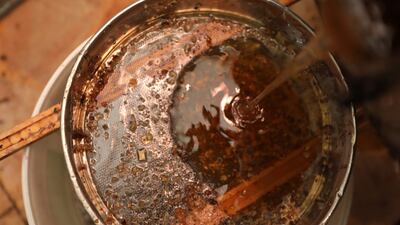 A Syrian beekeeper filters honey before packaging it for sale at a workshop in the town of Binnish in the rebel-held province of Idlib. AFP
