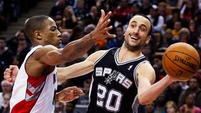 San Antonio Spurs' Manu Ginobili looks for a way round Toronto's DeMar DeRozan.