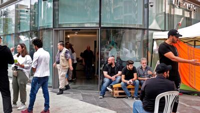 Lebanese protesters camp at the entrance of a bank in Beirut on November 1, 2019. AFP