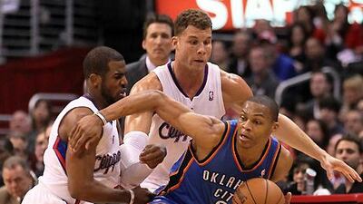 Oklahoma City Thunder's Russell Westbrook controls the ball against Chris Paul and Blake Griffin of the Clippers.