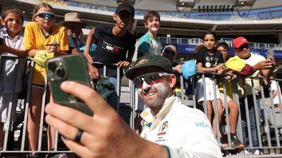 Nathan Lyon of Australia takes a selfie with fans after winning the first Test against Pakistan. EPA