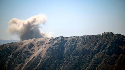 Smoke rising behind a hilltop after an Israeli demolition in Yohmor, Lebanon, where buildings were destroyed on Monday. AFP