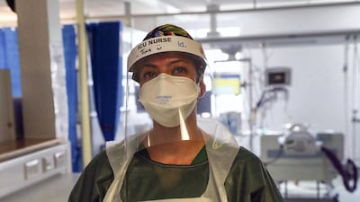 Nurse Tina has her name on her visor and a picture of herself on her apron in an intensive care unit where she is treating victims of the coronavirus in Frimley Park Hospital in Surrey. Getty Images